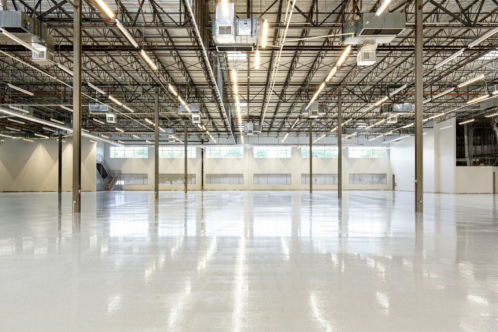 Large open commercial space with a flat, glossy concrete floor