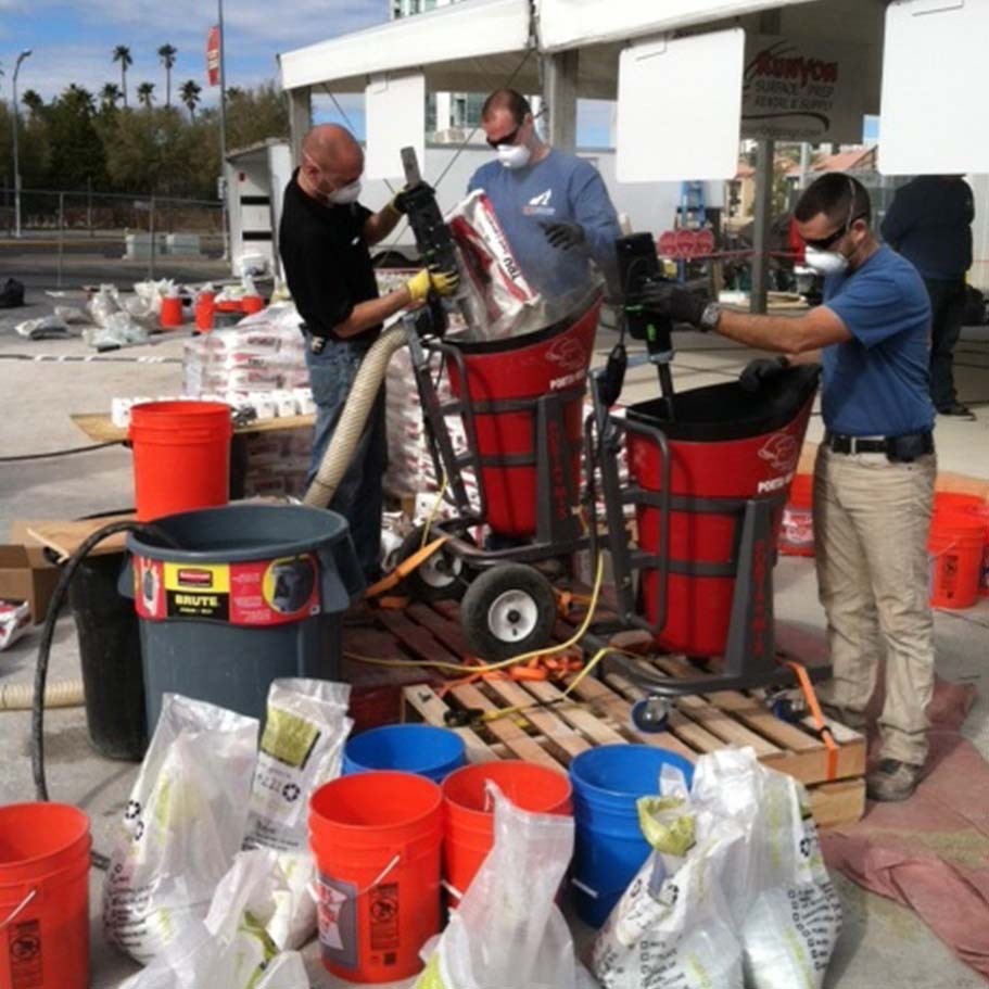 Crew mixing self-leveler bags into Portamix Mega Hippo stations